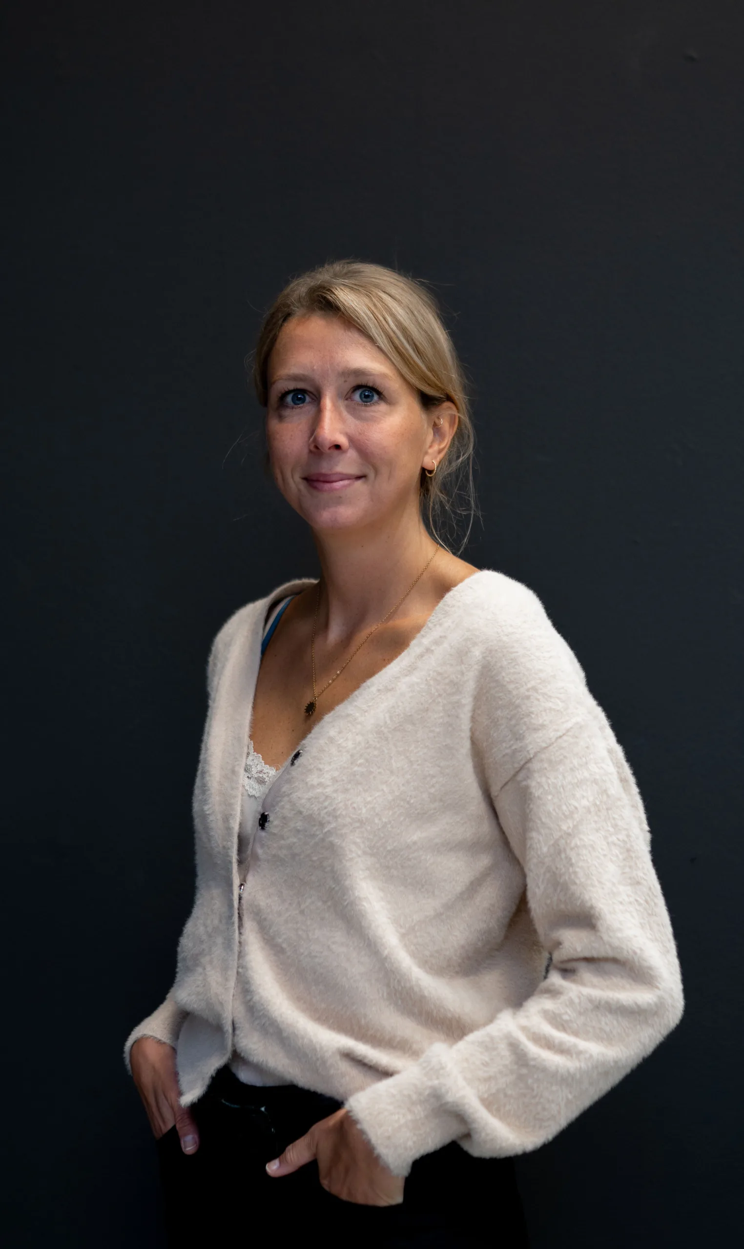 Colega poseert voor donkere muur