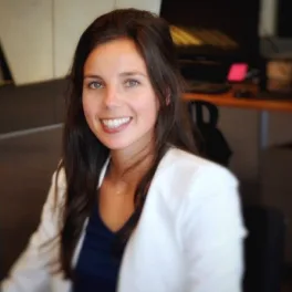 vrouw met donker haar en witte blazer